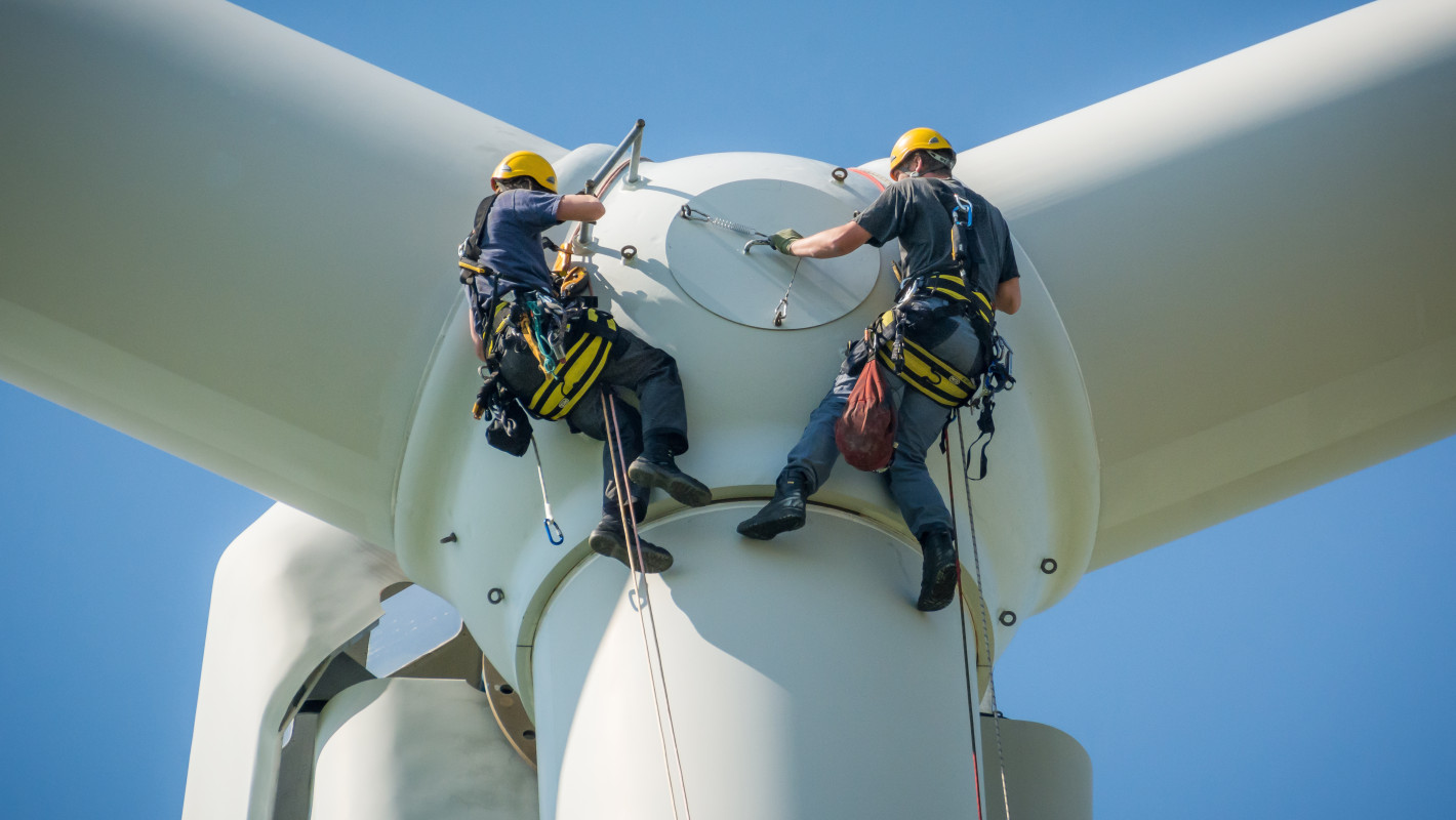 2 Arbeiter die sich von einer Windmühle abseilen